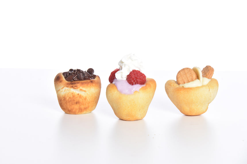 Wolf'em biscuit cup filled with pudding and pie filling.  Best campfire roasting stick with rotary handle